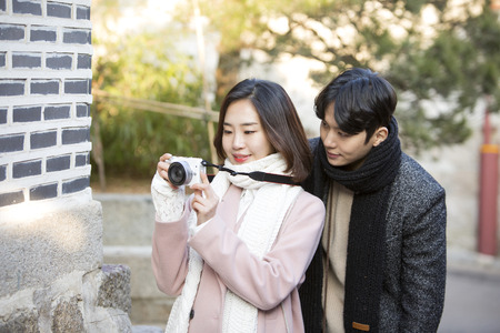 Asian couple dating in street - checking the camera togetherのeditorial素材