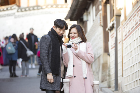 Asian couple dating in street - checking the camera togetherのeditorial素材