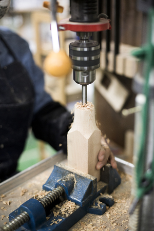 Isolated shot of hands of woodcraft experts making a piece with/using tools/machinesの写真素材