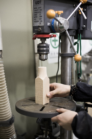 Isolated shot of hands of woodcraft experts making a piece with/using tools/machinesの写真素材