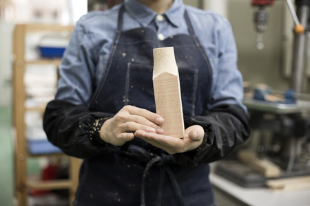 Isolated shot of hands of woodcraft experts combining completed pieces togetherの写真素材