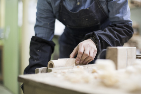 Isolated shot of hands of woodcraft experts combining completed pieces togetherの写真素材