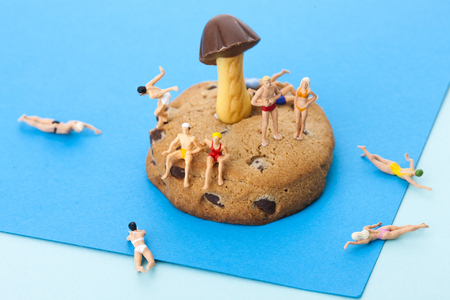 Creative miniature life - People/travelers/tourists in bathing suis on vacation on the beach/islandの写真素材
