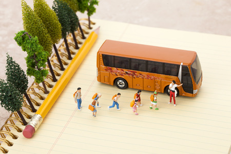 Creative miniature life - Kids/students/travelers getting onto a busの写真素材