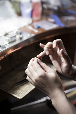 Isolated shot of bear hands of handmade craft jewerly experts making a pieceの写真素材