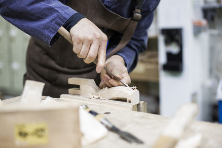 Isolated shot of hands of woodcraft experts making a piece with/using tools/machinesの写真素材