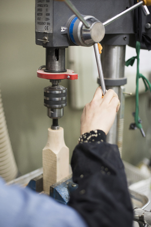 Isolated shot of hands of woodcraft experts making a piece with/using tools/machines