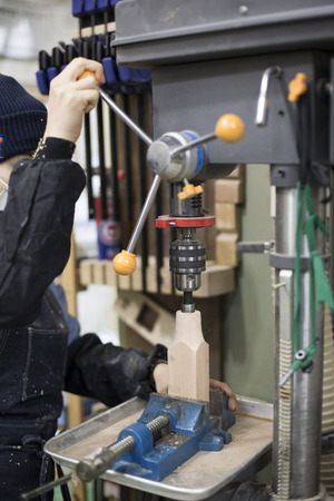 Isolated shot of hands of woodcraft experts making a piece with/using tools/machinesの写真素材
