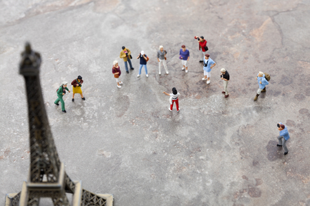 Creative miniature life - People/travelers/tourists watching the Eiffel tower in parisの写真素材