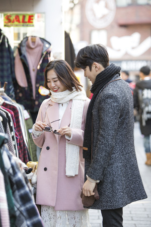 Asian couple dating in street - window shoppingの写真素材