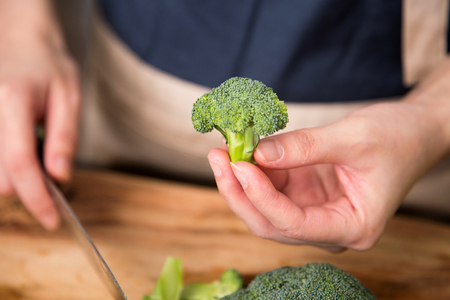 Isolated shot of cook's hands prepparing fresh ingredients - Broccoliの写真素材