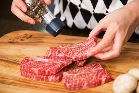 Isolated shot of cook's hands prepparing fresh ingredients - Beef/Steakの写真素材
