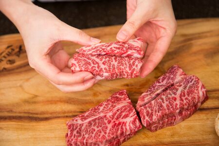 Isolated shot of cook's hands prepparing fresh ingredients - Beef/Steakの写真素材