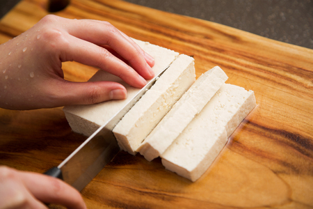 Isolated shot of cook's hands prepparing fresh ingredients - Bean curd/Tofuの写真素材