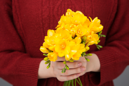 Isolated shot of hands holding flowers shoot in studio - Yellow flowersの写真素材