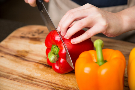 Isolated shot of cook's hands prepparing fresh ingredients - Colorful paprikasの写真素材