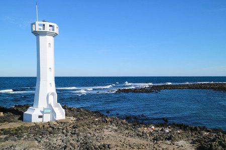 Scenery of the ocean inlet/light house of Jeju Islandの写真素材