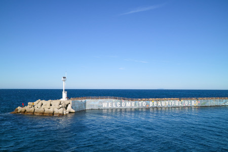 Scenery of the ocean inlet/light house of Jeju Islandの写真素材