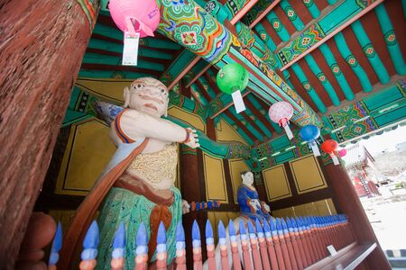 Buddhist temple in Korea - Round shape colorful lanterns and sculptures of heavenly kingsの写真素材