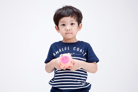 Isolated shot in studio - little Asian boy posing with various propsの写真素材