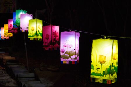 Buddhist temple in Korea - Close up shot of colorful lanterns lit at nightの写真素材