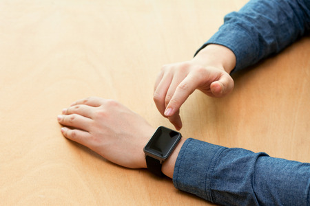 Isolated shot of hands and wrists operating/using smart watchの写真素材
