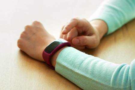 Isolated shot of hands and wrists operating/using smart watchの写真素材