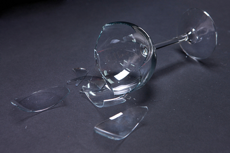 Damaged/Smashed/Broken wine glass in black backgroundの写真素材