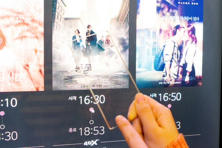 Isolated shot of hands holding/grabbing and operating/using transparent smart phoneの写真素材