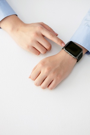 Isolated shot of hands and wrists operating/using smart watchの写真素材