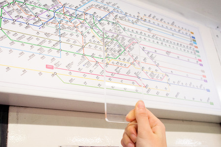 Isolated shot of hands holding/grabbing and operating/using transparent smart phone