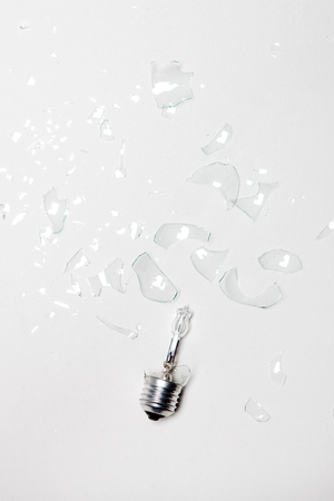 Damaged/Smashed/Broken lightbulb in white backgroundの写真素材