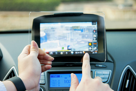 Isolated shot of hands holding/grabbing and operating/using transparent tablet PC with both hands