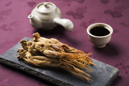 dried ginseng,on a Korean traditional roof tile and red ginseng extract