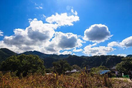 Autumn in countryside - country house with mountains in the backの写真素材