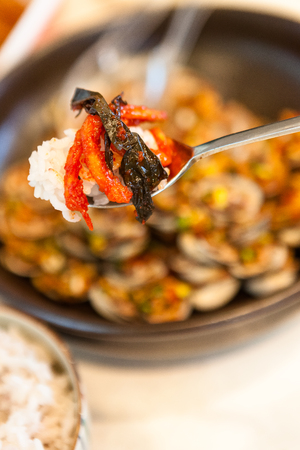 Korean dishes - a spoon of white rice with side dishesの写真素材