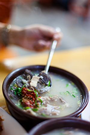 Korean traditional market - close up shot of a spoon in pork soupの写真素材