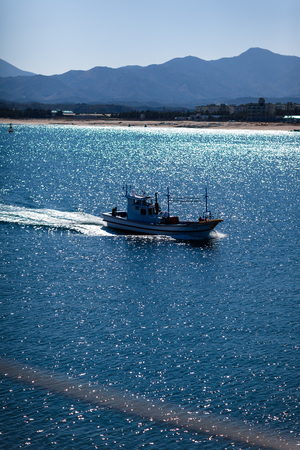 Fish boat sailing across oceanのeditorial素材