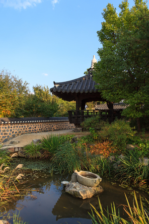 Scenery of pavilion with traditionally decorated pondの写真素材