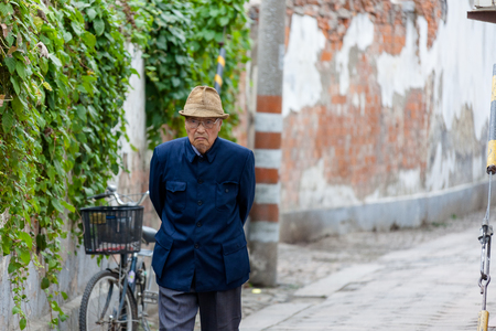 Suzhou, China - Old man walking in the streetのeditorial素材