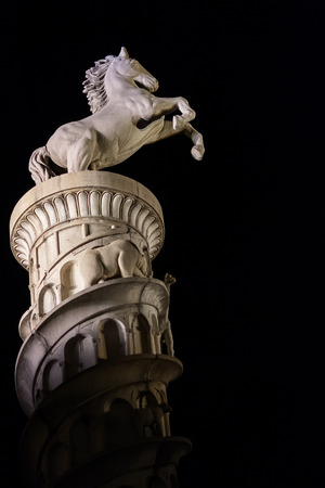 Lit statue of jumping horse at nightのeditorial素材