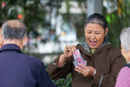 Suzhou, China - Three of seniors playing cardsのeditorial素材