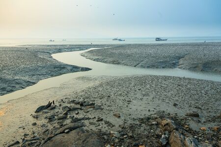 Waterways to the ocean during low tideの写真素材