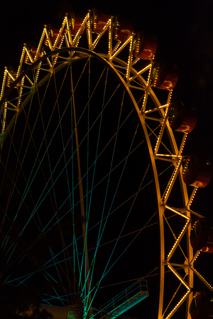Lit ferris wheel at nightの写真素材