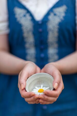 Korean folk village - Woman holding a teacup with a white flower in itの写真素材