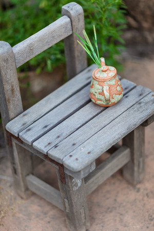Korean folk village - Pottery teapot on a school wooden chairの写真素材