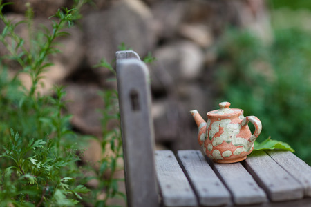 Korean folk village - Pottery teapot on a school wooden chairの写真素材