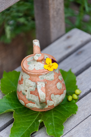 Korean folk village - Pottery teapot on a school wooden chairの写真素材