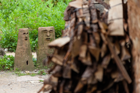 Korean folk village - Stacked loads of firewoods and pottery statueのeditorial素材