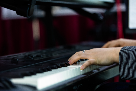 Isolated shot of hands playing the pianoの写真素材